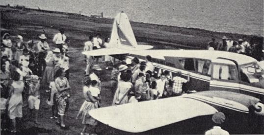 Sabans show their appreciation and great interest in twin-engine Apache's first landing on Saba's newly constructed airfield - Feb 1 1963